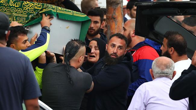 A woman overcome with grief approaches the pallbearers carrying the coffin of Hamad Assaad at Lakemba Mosque in Sydney’s west today. .