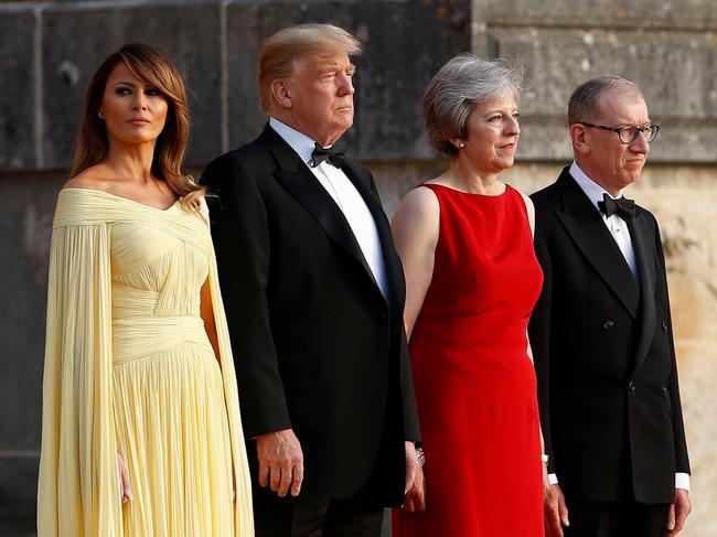British Prime Minister Theresa May and her husband Philip stand together with U.S. President Donald Trump and First Lady Melania Trump at the entrance to Blenheim Palace, where they are attending a dinner with specially invited guests and business leaders, near Oxford, Britain, July 12, 2018. REUTERS/Peter Nicholls - RC1DA1EE68B0