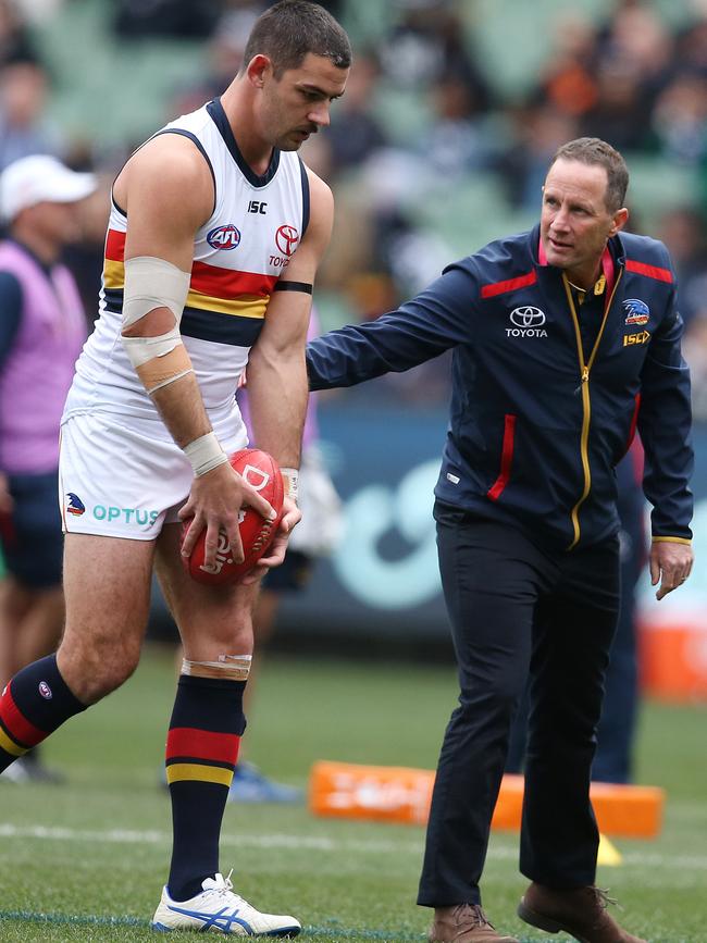 Crows coach Don Pyke encourages co-skipper Taylor Walker before the game against Carlton at the MCG. Picture: MICHAEL KLEIN