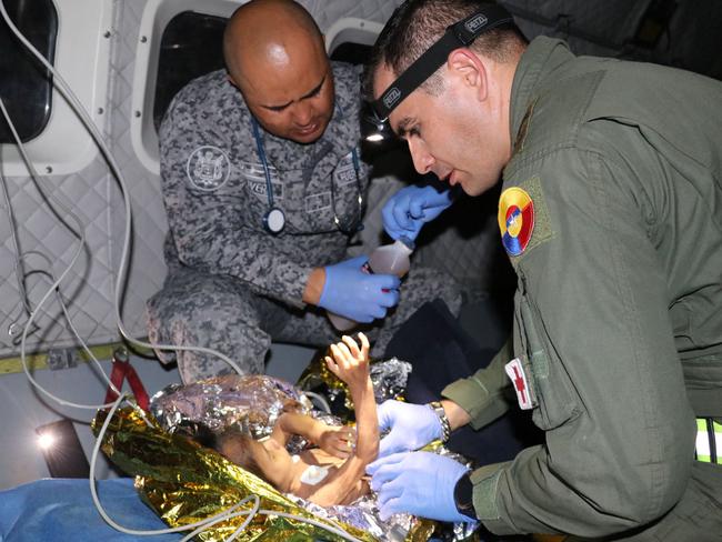 The Colombian Army checking one of the four indigenous children who were found alive after being lost for 40 days in the Colombian Amazon rainforest. Picture: Handout / Colombian Air Force / AFP