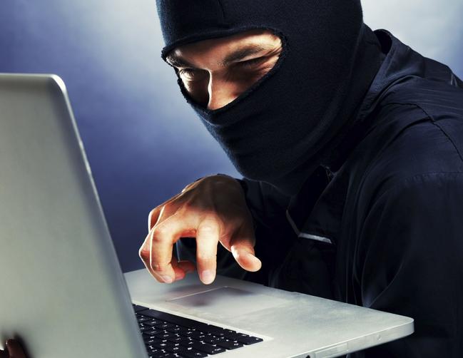 Computer hacker - Male thief stealing data from laptop