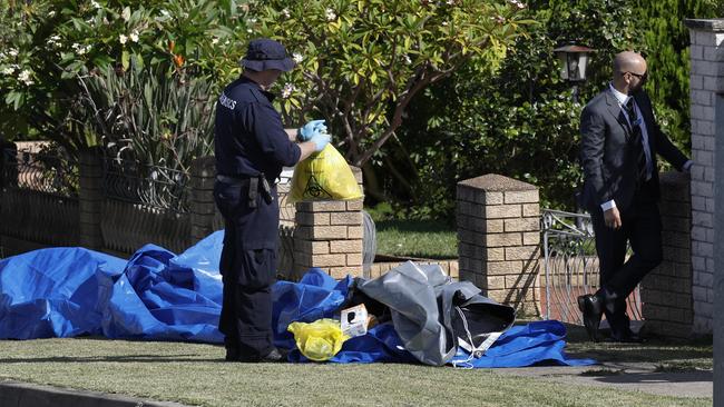 Investgators bag evidence at the scene. Picture: Richard Dobson