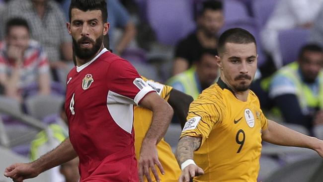 Jordan's midfielder Bahaha Abdel-Rahman, left, and Australia's forward Jamie Maclaren compete for the ball during the AFC Asian Cup group B soccer match between Australia and Jordan at the Hazza Bin Zayed stadium in Al Ain, United Arab Emirates, Sunday, Jan. 6, 2019. (AP Photo/Nariman El-Mofty)