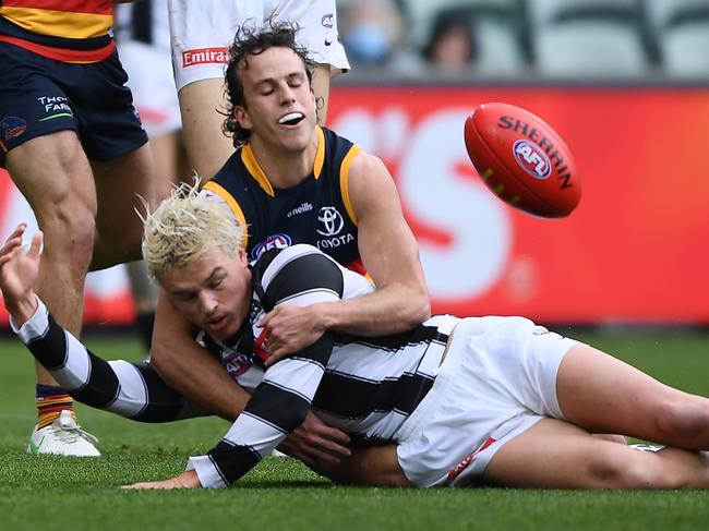 ADELAIDE, AUSTRALIA - JULY 16: Jack Ginnivan of the Magpies tackled by Will Hamill  of the Crows during the round 18 AFL match between the Adelaide Crows and the Collingwood Magpies at Adelaide Oval on July 16, 2022 in Adelaide, Australia. (Photo by Mark Brake/Getty Images)