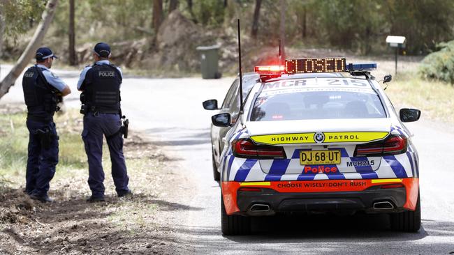 Police at a roadblock on Wilton Park Rd in Wilton, where they established a crime scene on Saturday. Picture: Damian Shaw