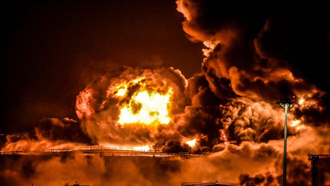 TOPSHOT - Smoke and flames rise from a Saudi Aramco oil facility in Saudi Arabia's Red Sea coastal city of Jeddah