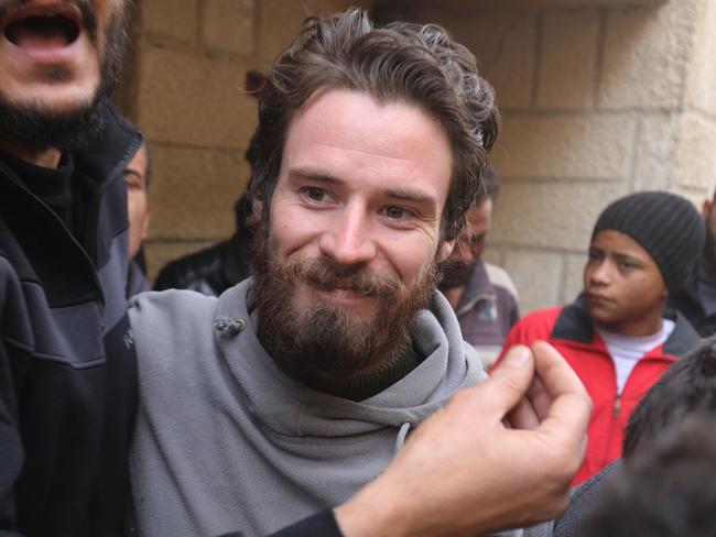 Travis Timmerman, a US citizen who had entered Syria from Lebanon on a Christian pilgrimage and had been detained for several months, speaks with reporters in a house in Damascus on December 12, 2024, after he was found in the village of Thihabiyeh east of the capital, after rebels toppled longtime president Bashar al-Assad. (Photo by Abdulaziz KETAZ / AFP)