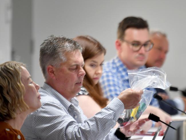 The State Health and Environment Committee is investigating the prevalence of vaping in Queensland, and met in Townsville on Wednesday. Thuringowa MP Aaron Harper inspects a bag of vapes. Picture: Evan Morgan