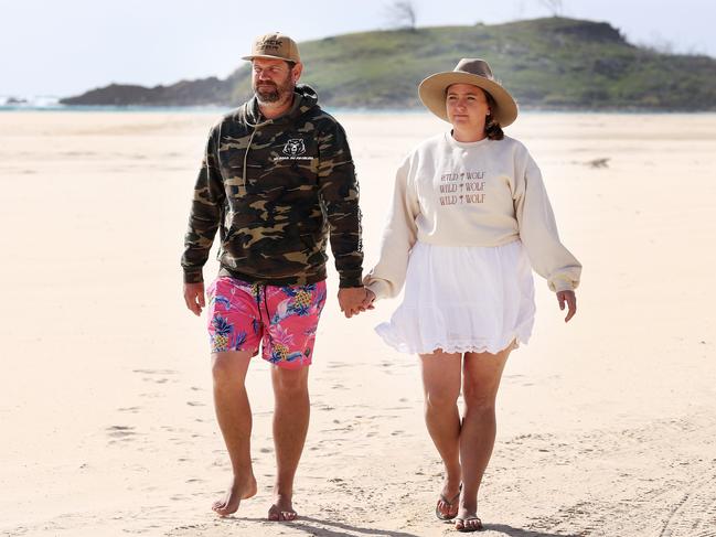 Shane and Sarah Moffat on the beach at Waddy Point on K’gari on Thursday. The Glass House Mountains couple said they will continue to visit the island despite a recent dingo attack on a woman they helped rescue. Picture: Liam Kidston