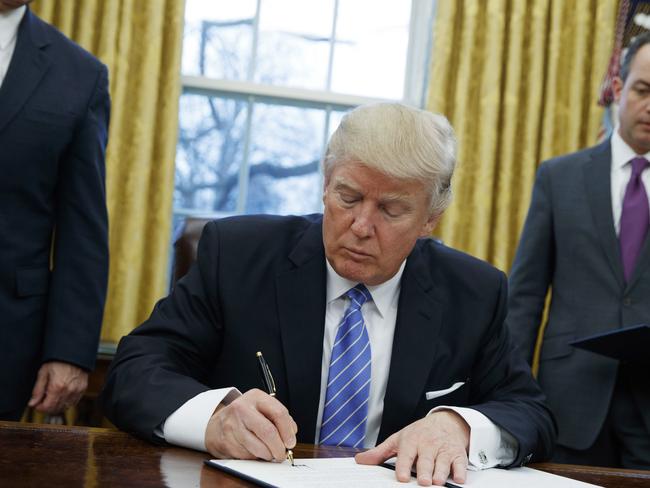 President Donald Trump signs an executive order to withdraw the US from the 12-nation trans-Pacific Partnership trade pact. Picture:Evan Vucci.