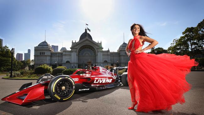 PayPal Melbourne Fashion Festival model Saffire Leparporit, wearing Jason Grech, with the Melbourne Grand Prix Formula 1 car at the Royal Exhibition Building. Picture: David Caird