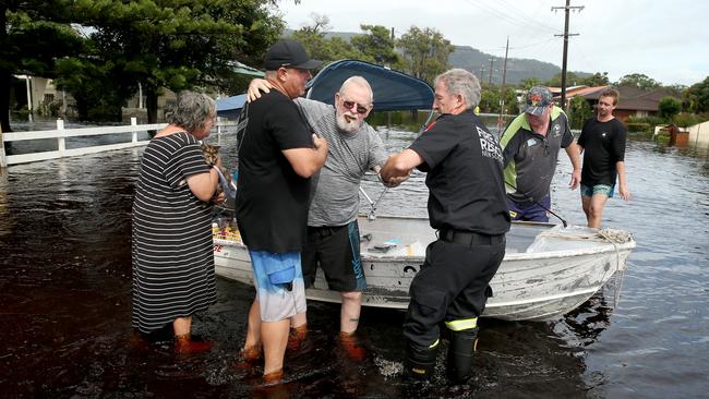 North Haven resident Jack Jennings and his cat Buffy are rescued from the flood waters. Picture: Nathan Edwards