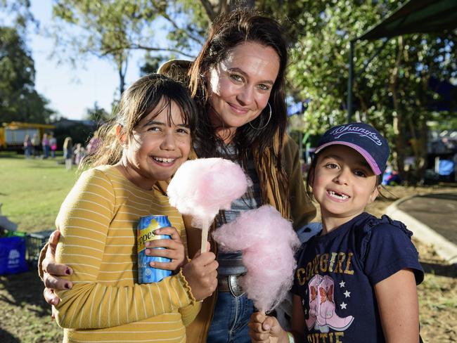 Amy Doomadgee with daughters Dixie (left) and Isabella Doomadgee enjoy fairy floss at Sadie's Day Out, a special community event to celebrate the life of five-year-old crash victim Sadie, held at Cambooya State School, Saturday, June 7, 2025. Picture: Kevin Farmer
