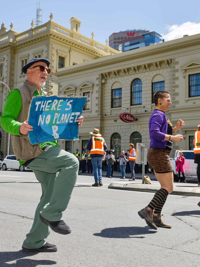 Extintion Rebellion members dance to Nutbush City Limits on Flinders St. Picture: AAP Image/Brenton Edwards