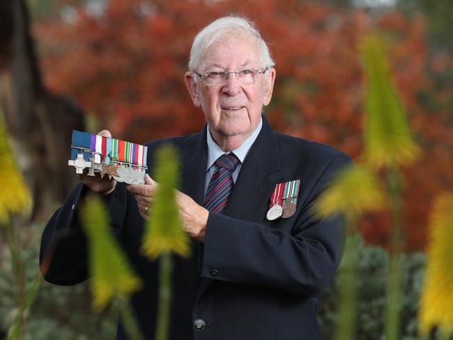 David Matthews holds his replica medals including the Military Cross and George Cross awarded to his father, Captain Lionel "The Duke" Matthews. Picture: Tait Schmaal