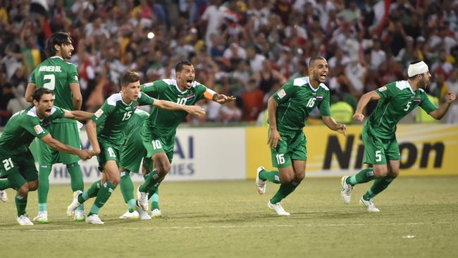 Iraq celebrate the moment they beat Iran on penalties in their AFC Asian Cup quarter-final football match in Canberra on January 23, 2015. AFP PHOTO/Peter PARKS --IMAGE RESTRICTED TO EDITORIAL USE - STRICTLY NO COMMERCIAL USE