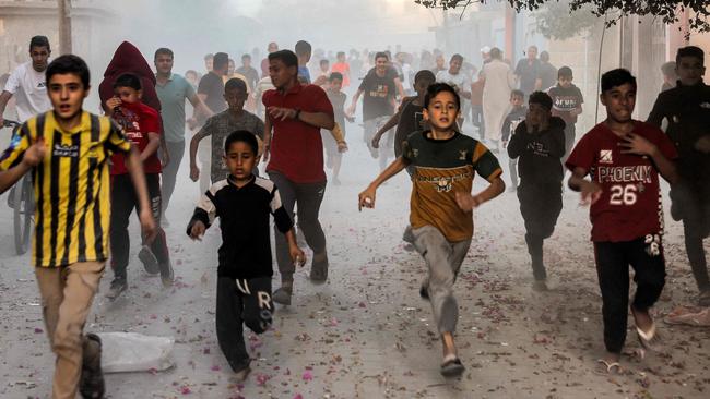 Palestinian children run as they flee from Israeli bombardment in Rafah in the southern Gaza Strip. Picture: AFP