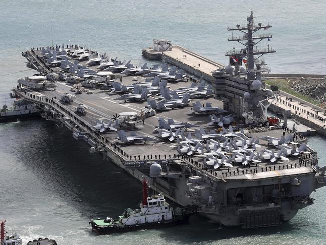 The aircraft carrier USS Ronald Reagan (CVN 76) is escorted into Busan port, South Korea, after completing a joint drill with the South Korean military. Picture: AP