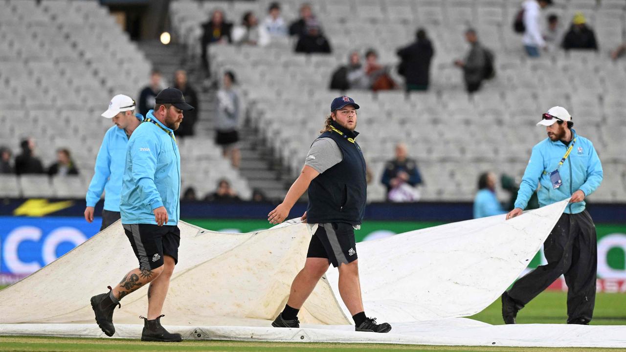 Ground staff remove the covers.