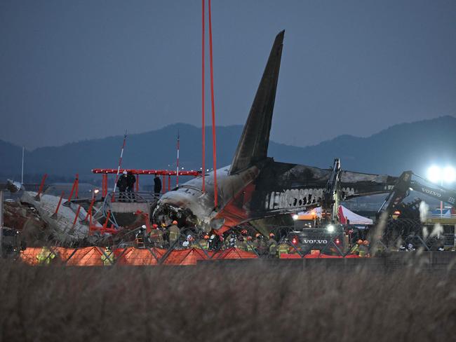 Firefighters and rescue personnel work near the scene where a Jeju Air Boeing 737-800 series aircraft crashed and burst into flames at Muan International Airport. Picture: AFP