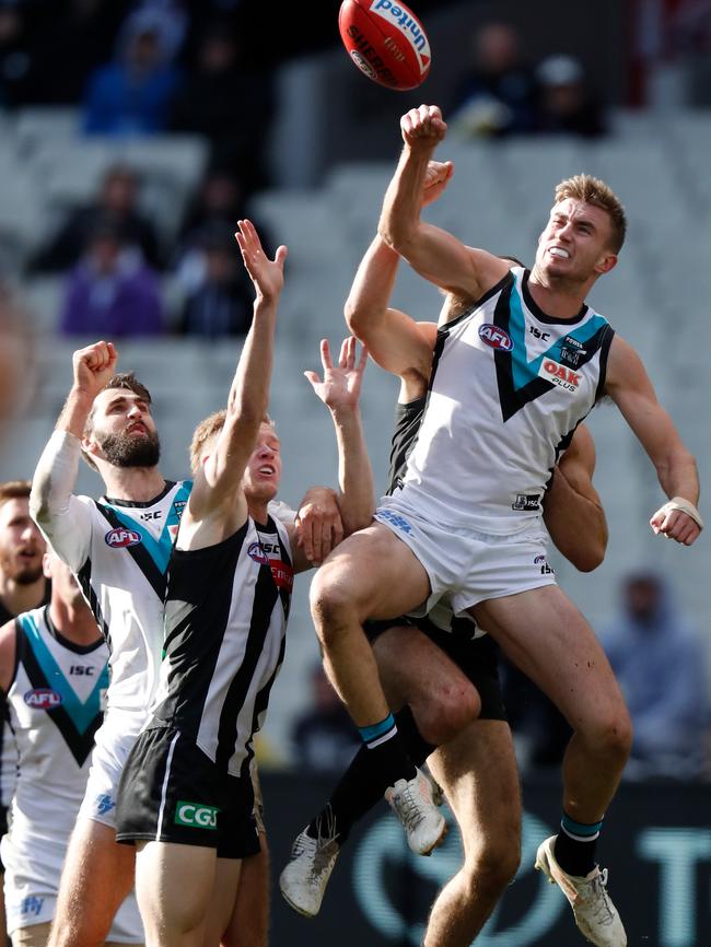 Dougal Howard of the Power flies over Jaidyn Stephenson for a spoil against Collingwood. He has been a leading light in Port’s defensive half. Picture: Michael Willson/AFL Media/Getty Images