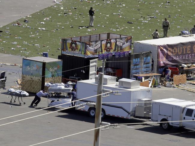 Investigators loads a truck with bodies from the scene of the horror shooting. Picture: AP