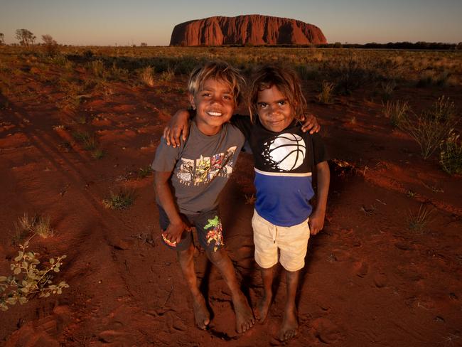 11-10-2023 - Anangu woman Rita Jingo, who lives in Mutitjulu, with her two grandchildren Jonah Dunn, 5, and Nicholas Forbes, 7. Picture: Liam Mendes / The Australian