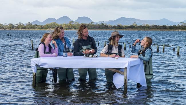 Kate and Dan de Boer and daughters Lola, left, and Isla, right, with Renee Harris get the Freycinet oyster experience.