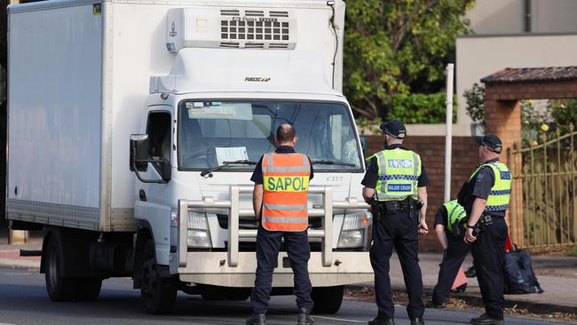 SA Police Major Crash officers analyse the scene on Kensington Rd. Picture: NewsWire/David Mariuz