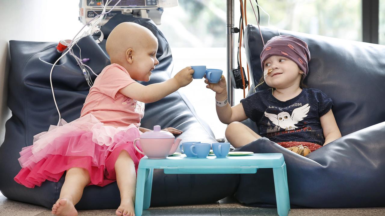 The Royal Children’s Hospital Good Friday Appeal helps sick children like Charlotte Alexander, who had a large tumour removed, and fellow cancer patient Luna Phillips, who still had time to enjoy a tea party in 2021 despite treatment for their illnesses. Picture: David Caird