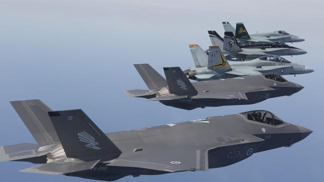 A35-010 and A35-009, F-35A Joint Strike Fighter fly in formation with F/A-18 Hornets.