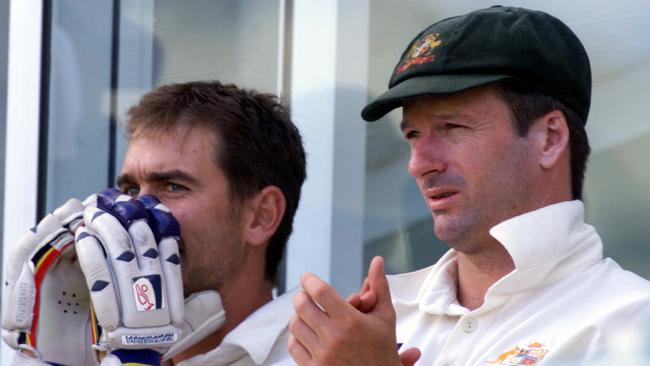 Former Test teammates Justin Langer (left) and Steve Waugh watch on from the sidelines against Pakistan at the Gabba in 1999.