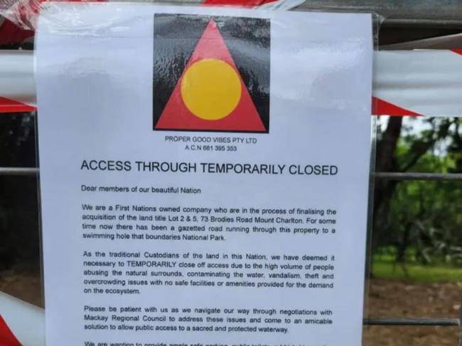 A sign with an Aboriginal flag has been placed on Brodies Rd, which leads to the waterhole, declaring “access through temporarily closed … due to the high volume of people abusing the natural surrounds, contaminating the water, vandalism, theft and overcrowding issues”. Picture: Supplied