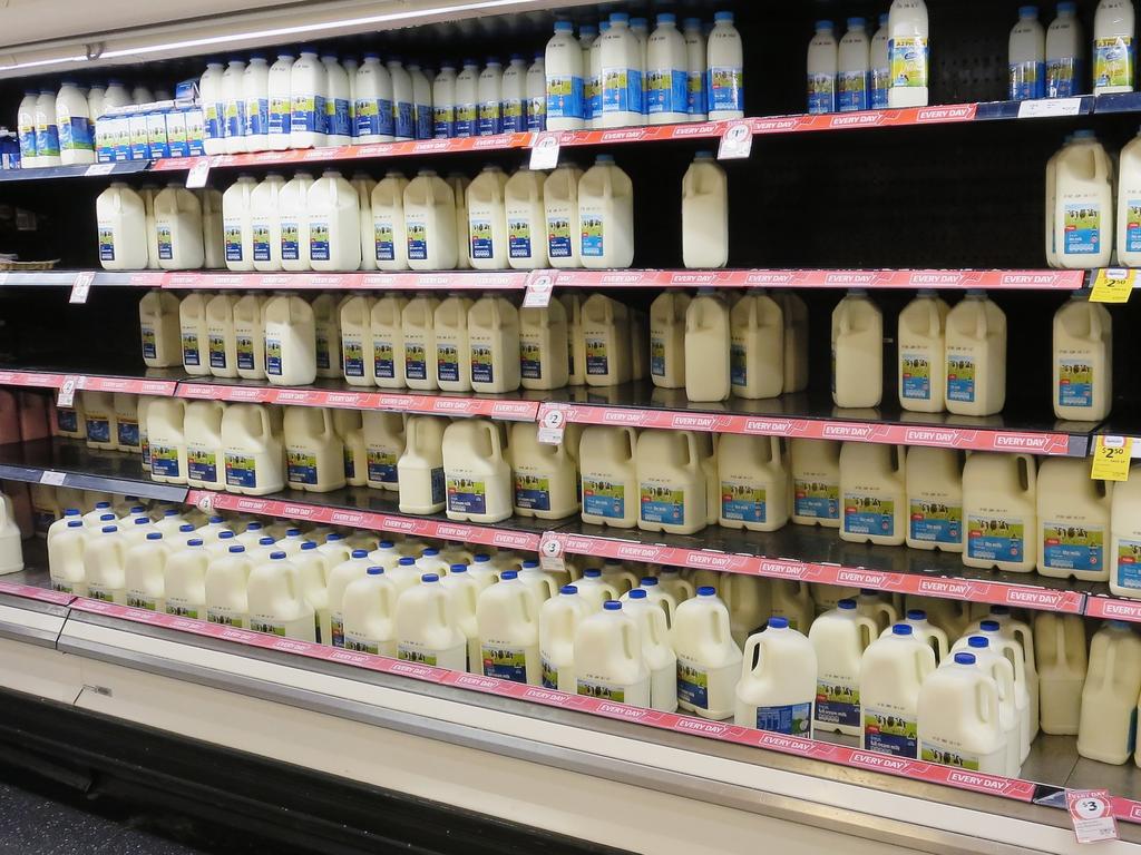 Coles and Woolworths will increase the price of their own branded milk from this week. Picture: Getty Images