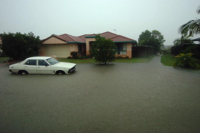 Gold Coast, June 30, 2005. Floodwaters at a housing estate at Robina on Queensland’s Gold Coast today. Widespread flooding has hit the popular tourist area, known for its sunshine and sandy beaches, with reports of rainfall reaching 80mm per hour in some regions. (AAP Image/Tony Phillips)