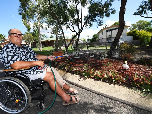 Ken Lidster watering the traffic island in front of his house.