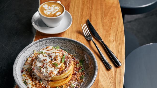 Buttermilk pancakes with white chocolate snow, caramel, passionfruit and yoghurt anglaise. Picture: Griffin Simm.