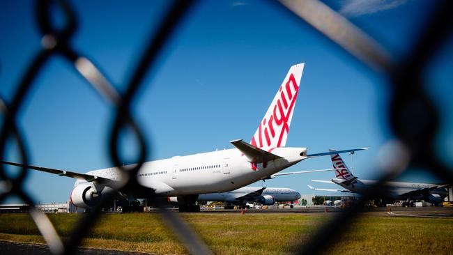 Virgin Australia aircraft are seen parked on the tarmac at Brisbane International airport on April 21, 2020. Picture: AFP