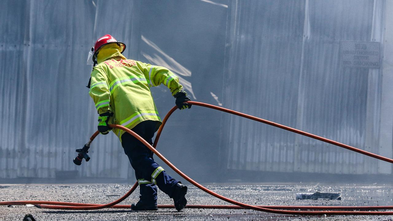 Firefighters worked for hours in the heat to tackle a massive blaze in Berrimah last August. Picture: Glenn Campbell