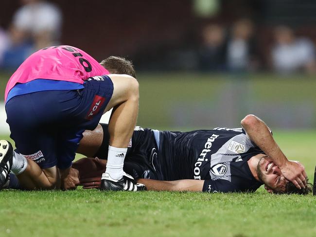 Terry Antonis of the Victory receives attention during the Round 24 A-League match between Sydney FC and Melbourne Victory at the SCG in Sydney, Saturday, April 6, 2019. (AAP Image/Brendon Thorne) NO ARCHIVING, EDITORIAL USE ONLY