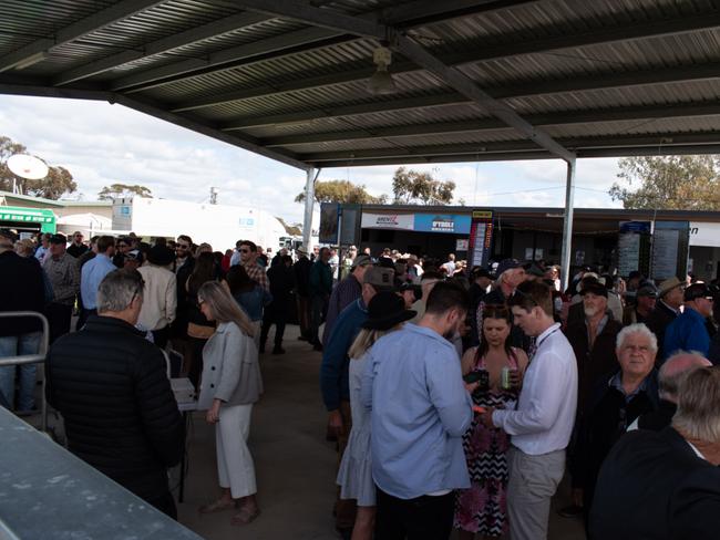 Racegoers placing bets.