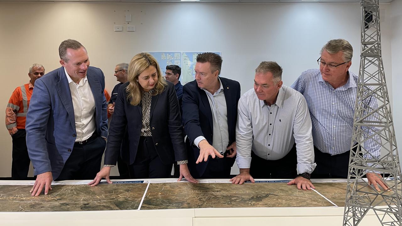 Premier Annastacia Palaszczuk and co inspect a map of the upcoming CopperString SuperGrid power transmission line, set to run from Townsville to Mount Isa.