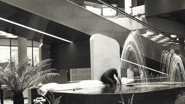 A worker putting the final touches to the fountain at Whitehorse Plaza in 1974. It was the first time moving walkways were used in a shopping centre in Victoria. Picture: Max Williams Photography.