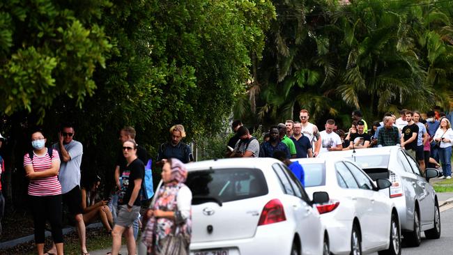 People are seen in a long queue outside a Centrelink office in Brisbane at the end of March. Picture: AAP Image/Dan Peled