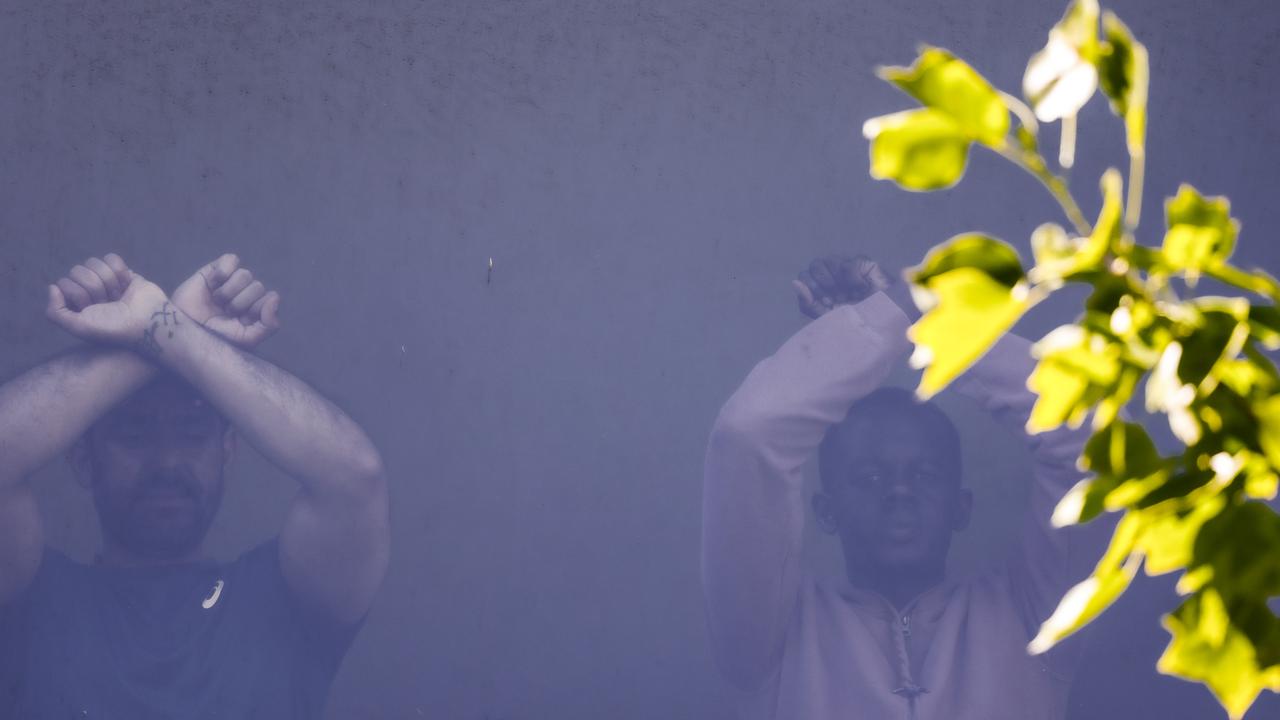 Refugees can be seen in a window of the hotel. Picture: NCA NewsWire / Ian Currie