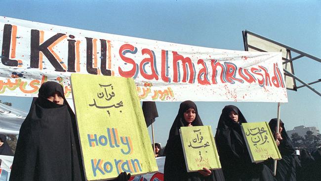 Iranian women in 1989 seen holding banners which read "Holly Koran" and "Kill Salman Rushdie". Picture: AFP