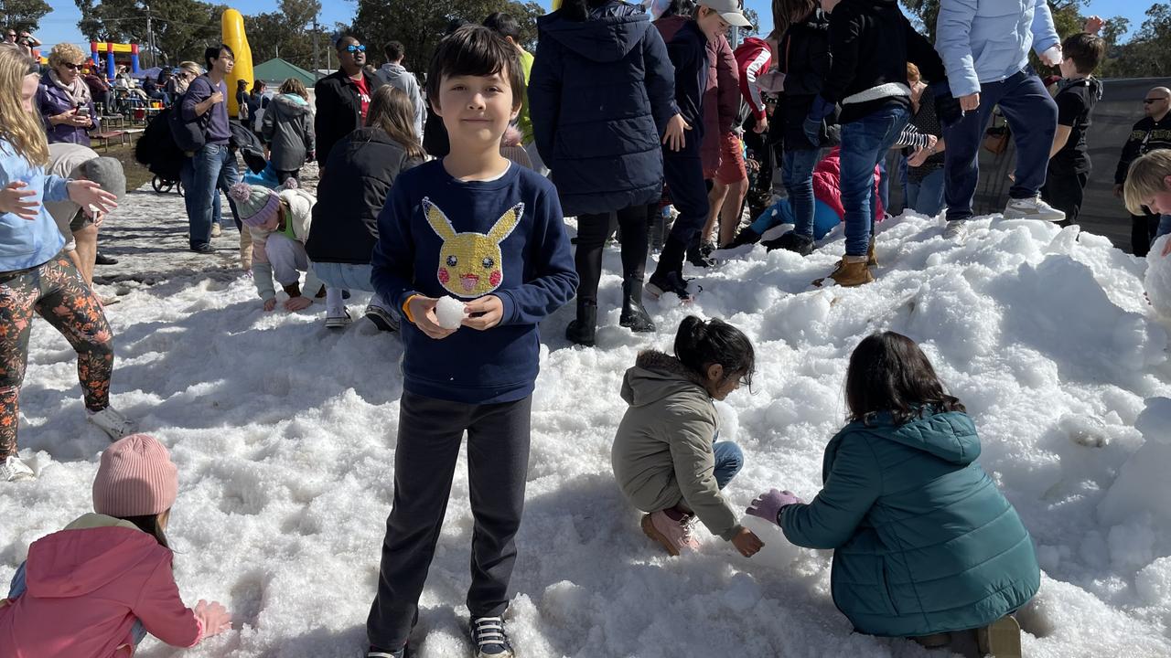 Nine-year-old Charlie Hunter makes snowballs in the snowfields at the 2021 Snowflakes in Stanthorpe festival. Photo: Madison Mifsud-Ure / Stanthorpe Border Post