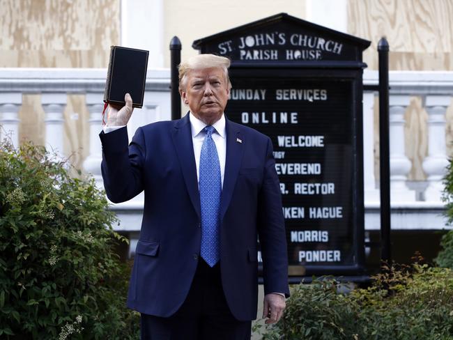 President Donald Trump holds a Bible during his visit outside St. John’s Church near the White House, last Monday. Protesters were cleared with tear gas to make way for Trump’s photo. Picture: AP / Patrick Semansky