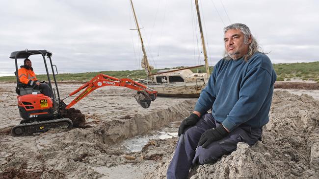 Mid North resident Claude Evans and son Samuel trying to rescue their yacht at North Haven. Picture: Tom Huntley