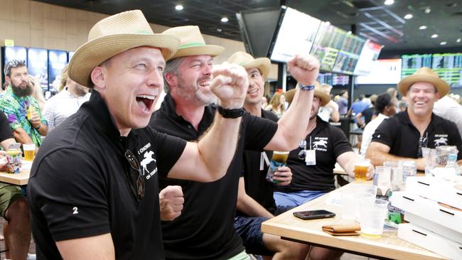 Winners are grinners ... Peter Harris, Bruce Teichert and Lesley Chow celebrate their win on the Cup at The Gold Coast Turf Club.